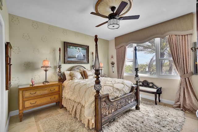 bedroom with ceiling fan and baseboards