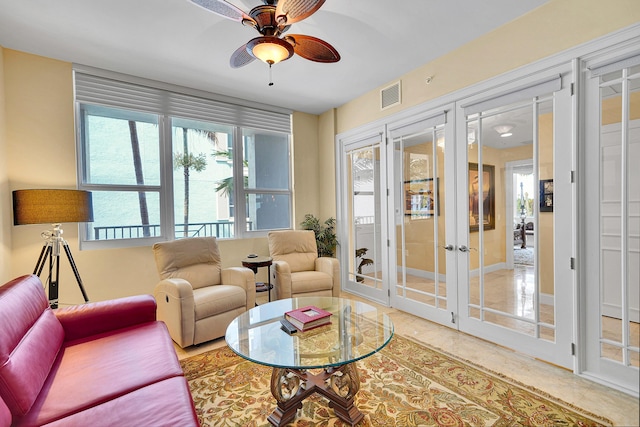 living room with visible vents, a ceiling fan, and french doors