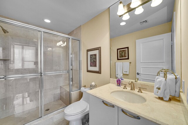 full bathroom with recessed lighting, visible vents, toilet, a stall shower, and vanity