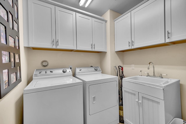 laundry area with a sink, cabinet space, and washer and dryer