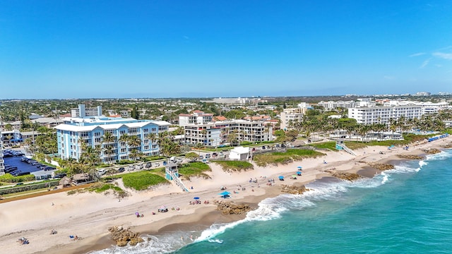 bird's eye view featuring a water view, a view of city, and a beach view