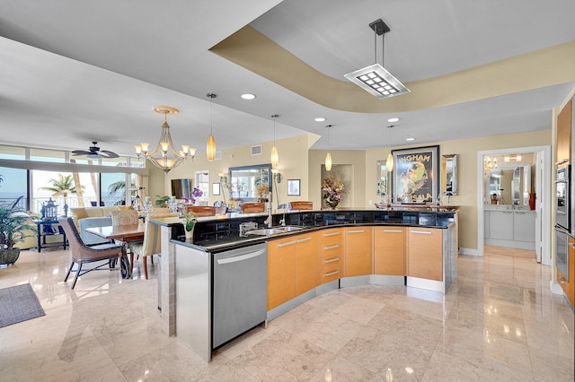 kitchen featuring decorative light fixtures, a spacious island, appliances with stainless steel finishes, open floor plan, and a sink