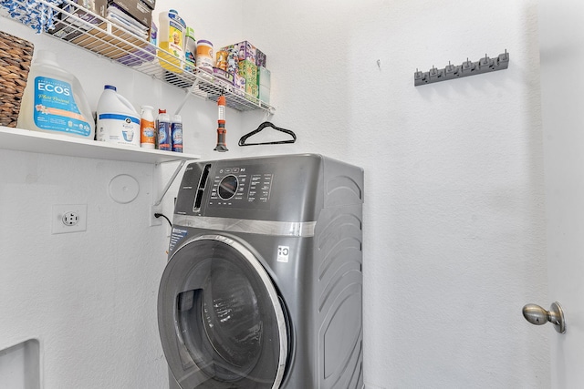 clothes washing area featuring washer / dryer and laundry area