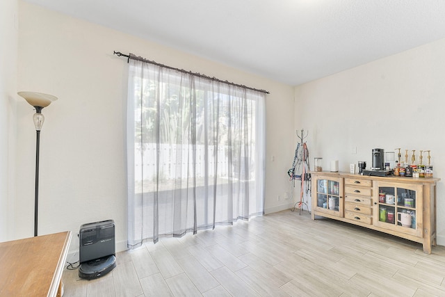 interior space with heating unit, baseboards, and wood finish floors