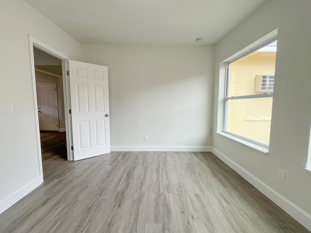 empty room with wood finished floors and baseboards