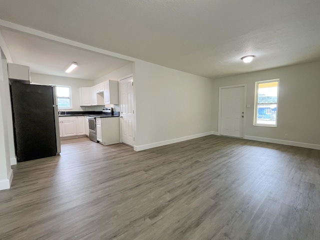 interior space with wood finished floors and baseboards