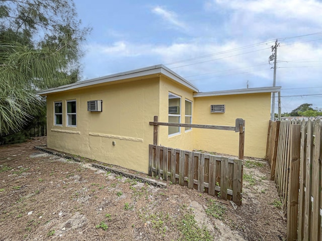 view of property exterior with fence and stucco siding