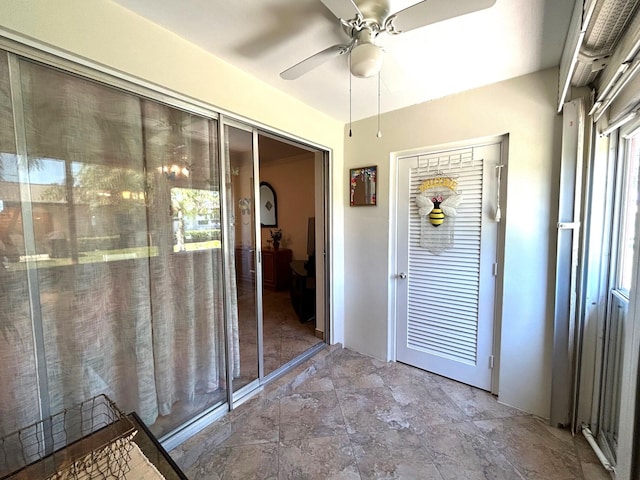 interior space with stone finish floor and ceiling fan