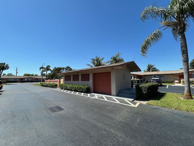 single story home featuring an attached garage and stucco siding