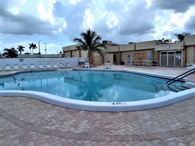 pool featuring a patio area and fence