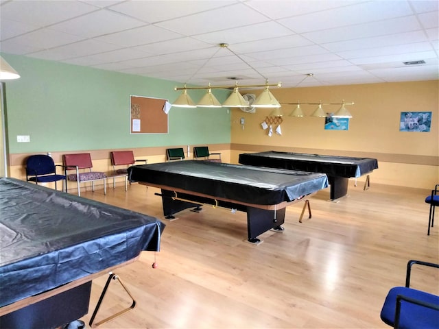 recreation room with pool table, a paneled ceiling, wood finished floors, and visible vents