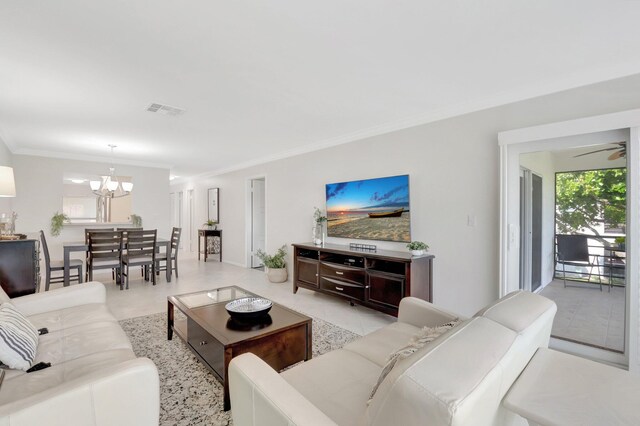 living area with visible vents, crown molding, and ceiling fan with notable chandelier