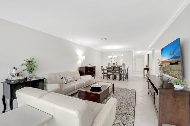 living area with light tile patterned flooring, visible vents, crown molding, and an inviting chandelier