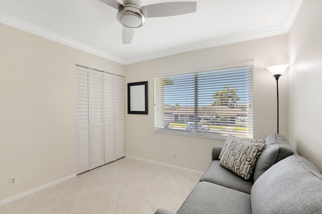 sitting room featuring crown molding, light tile patterned floors, baseboards, and ceiling fan