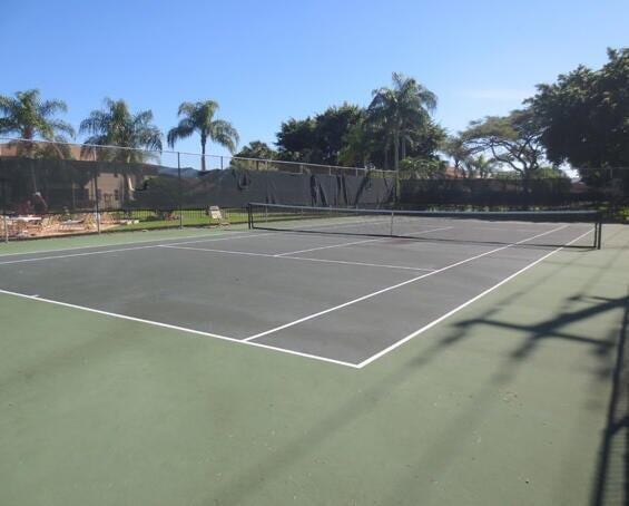 view of tennis court with fence