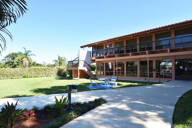 surrounding community featuring a yard and stairs