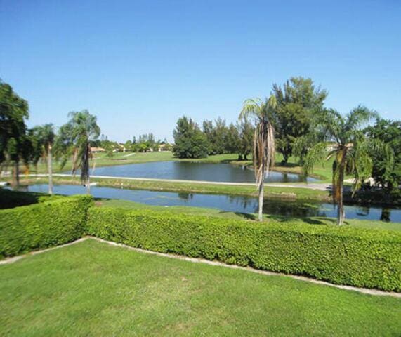 view of community with a lawn and a water view