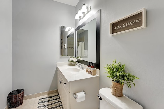 123 E Prive Cir, Delray Beach, FL 33445 - full bathroom featuring toilet, vanity, baseboards, and tile patterned floors
