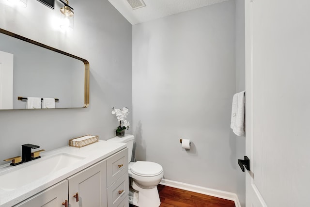 123 E Prive Cir, Delray Beach, FL 33445 - bathroom with toilet, vanity, wood finished floors, and baseboards