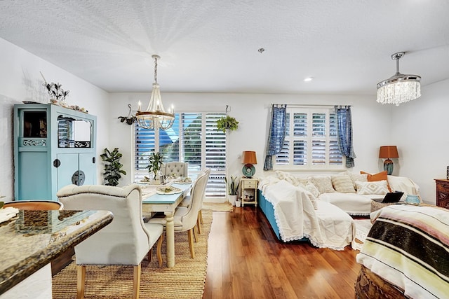 123 E Prive Cir, Delray Beach, FL 33445 - dining space featuring a chandelier, wood finished floors, and a textured ceiling