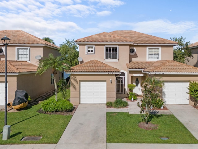 mediterranean / spanish home with a front yard, driveway, an attached garage, and stucco siding