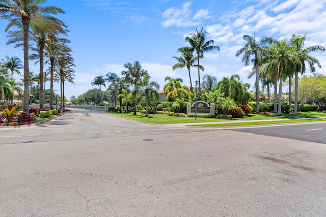 view of street with a gate and curbs