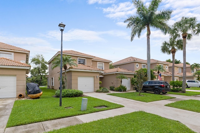 townhome / multi-family property with a garage, concrete driveway, a front yard, and stucco siding