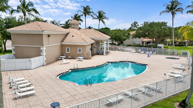 community pool featuring a patio area and fence