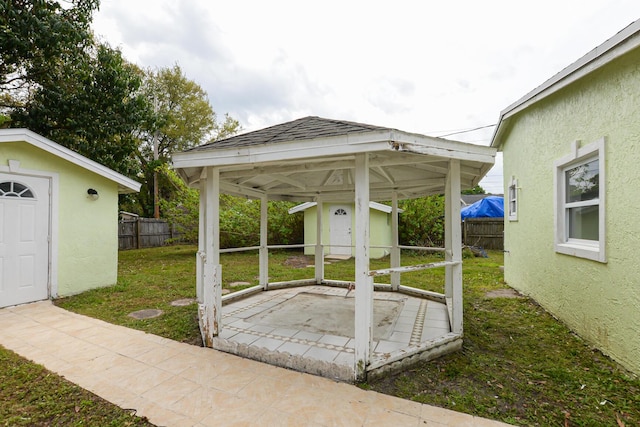 view of patio with an outbuilding, a fenced backyard, a gazebo, and a storage unit