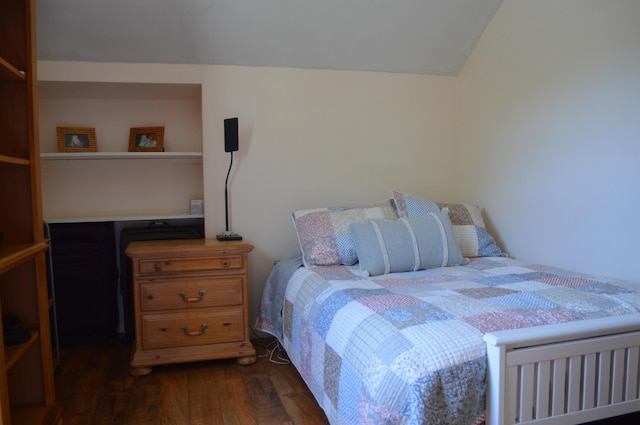 bedroom featuring dark wood finished floors and lofted ceiling