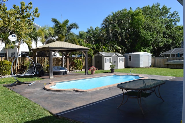 view of swimming pool with a gazebo, a storage unit, a patio, and fence