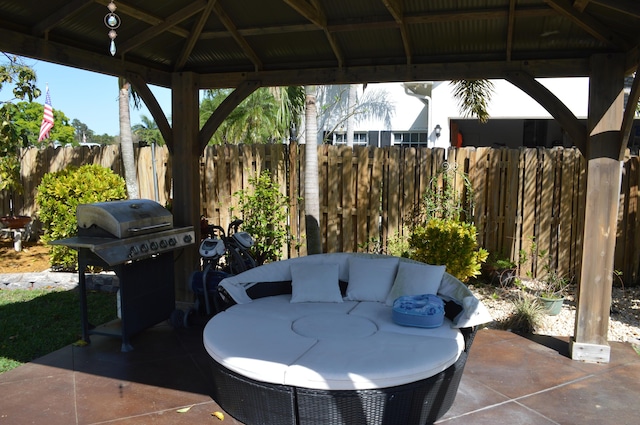 view of patio / terrace featuring a gazebo, area for grilling, and fence