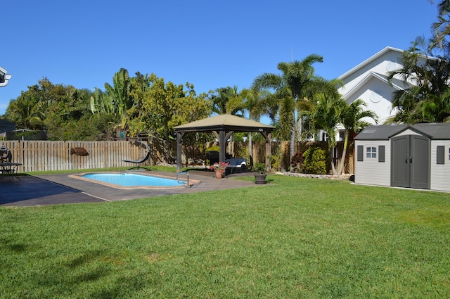 view of yard featuring a shed, a fenced backyard, a gazebo, an outdoor structure, and a patio area