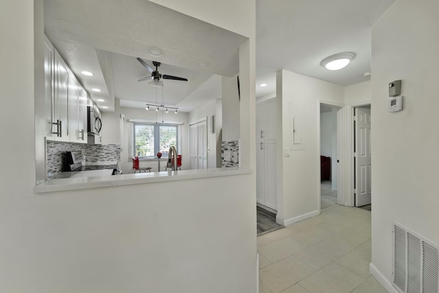 kitchen featuring ceiling fan, visible vents, light countertops, appliances with stainless steel finishes, and decorative backsplash