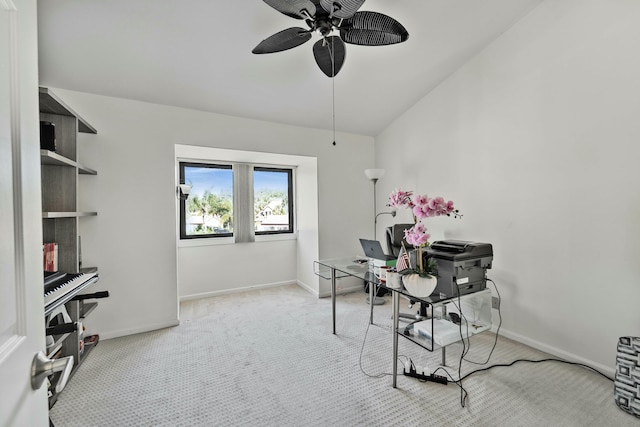 carpeted office space with baseboards and a ceiling fan