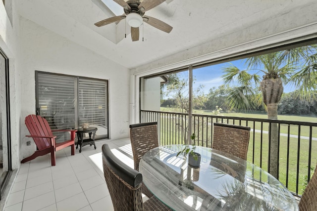 sunroom / solarium featuring lofted ceiling and ceiling fan