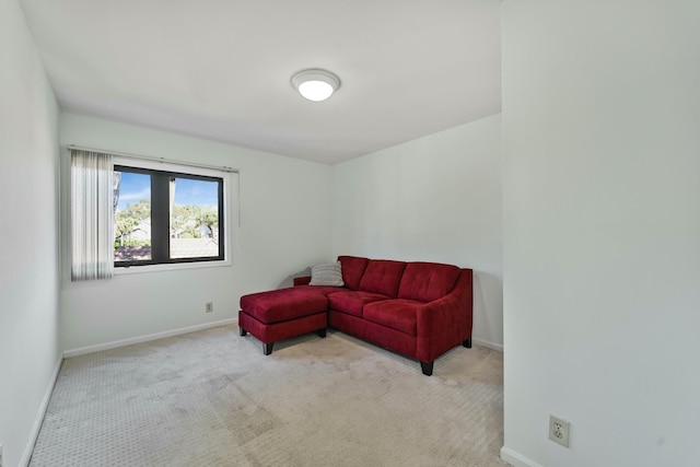 living room featuring light carpet and baseboards