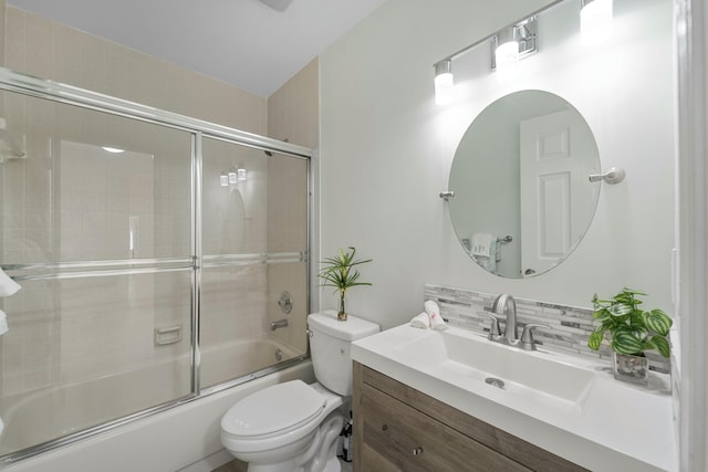 full bathroom featuring enclosed tub / shower combo, vanity, backsplash, and toilet