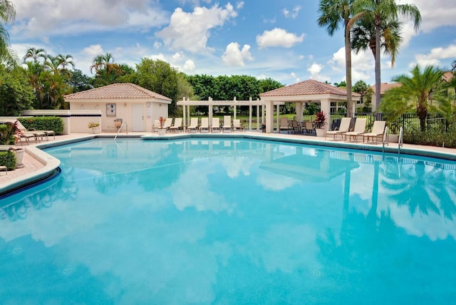 community pool featuring a patio area, fence, and a gazebo