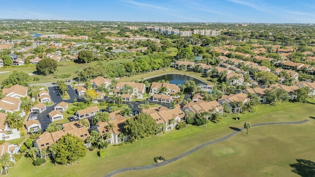 birds eye view of property with view of golf course, a water view, and a residential view