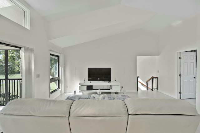 living room featuring high vaulted ceiling