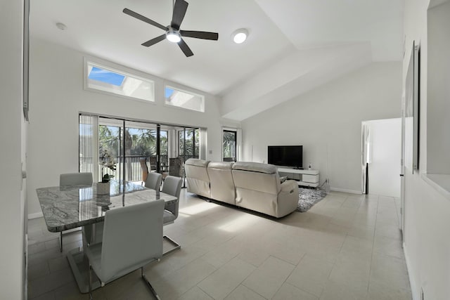 dining room featuring baseboards, high vaulted ceiling, and a ceiling fan