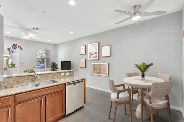 kitchen featuring a ceiling fan, a sink, light stone counters, recessed lighting, and dishwasher