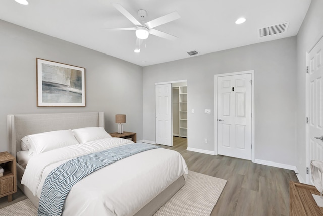 bedroom featuring visible vents, recessed lighting, baseboards, and wood finished floors