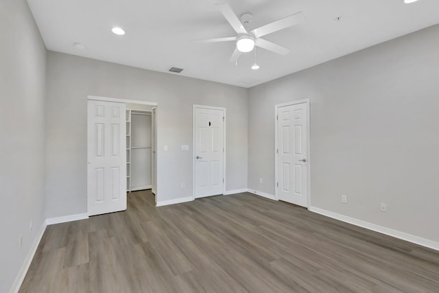 unfurnished bedroom featuring visible vents, baseboards, recessed lighting, wood finished floors, and a ceiling fan