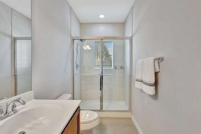 full bathroom featuring vanity, toilet, baseboards, and a stall shower