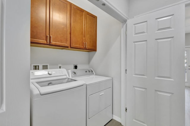 laundry room with cabinet space and washing machine and clothes dryer