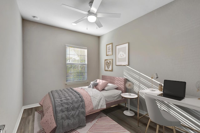 bedroom featuring ceiling fan, baseboards, and wood finished floors