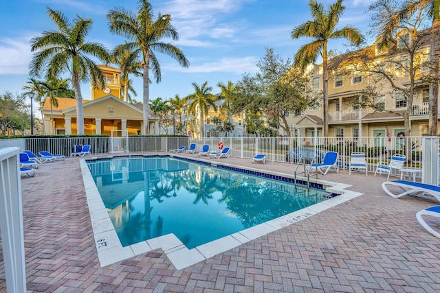 community pool featuring a patio and fence