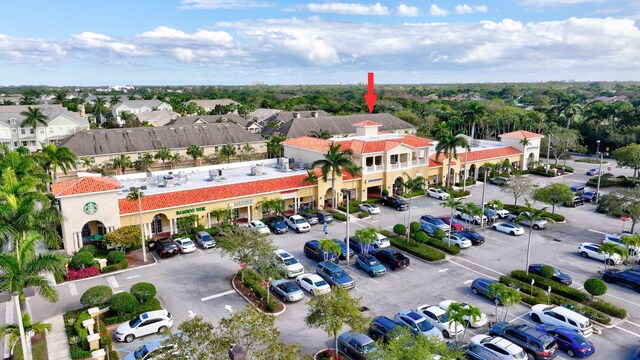 birds eye view of property with a residential view, golf course view, and a water view